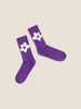 Purple daisy socks with white flowers on a pair of socks.